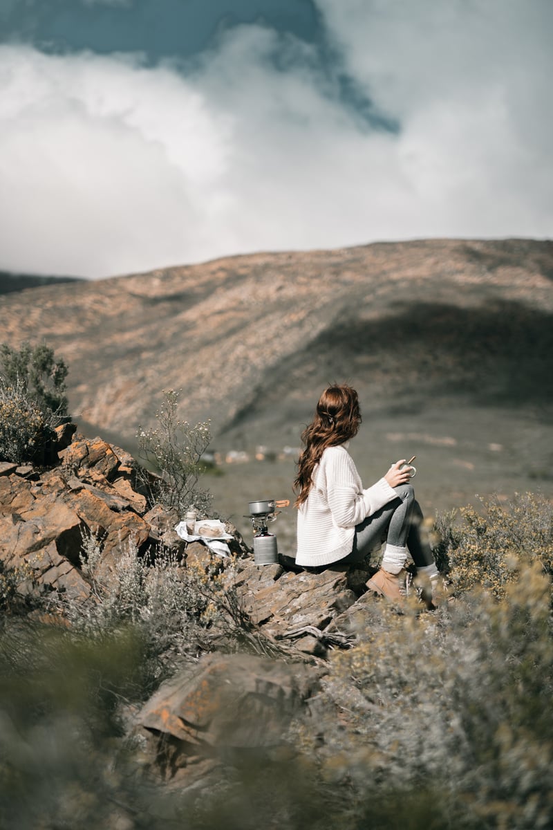  Woman Holding a Cup Overlooking Rocky Valley